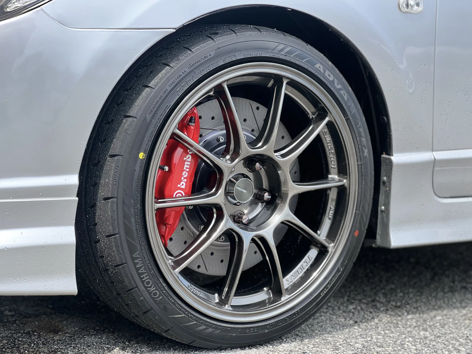 Close-up of a dark performance rim with a red Brembo brake caliper